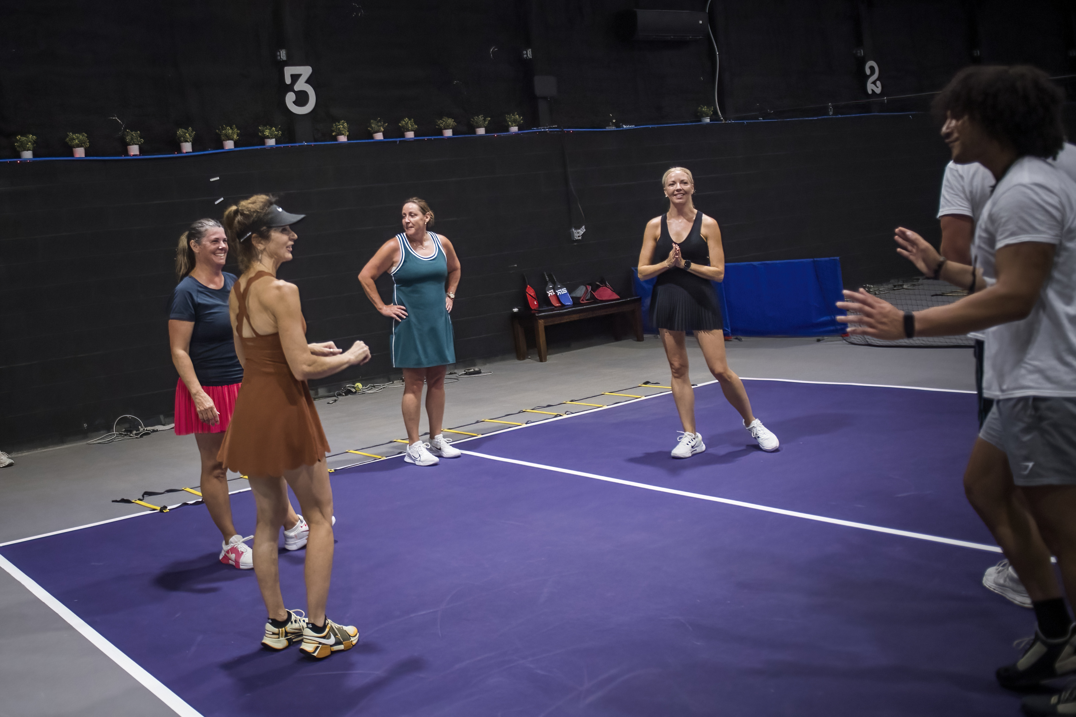 Group fitness session in progress on a purple court